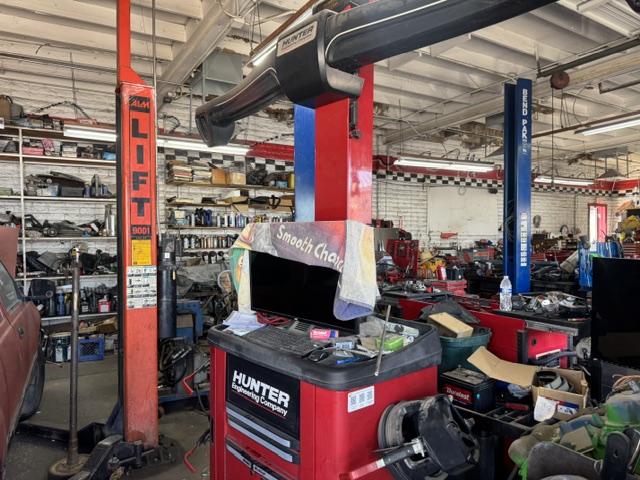 Inside the shop showing the Hunter wheel alignment machine and lift bays